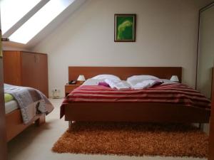 a bedroom with a bed and a skylight at Luxury Apartment in Bešeňová +21 photos