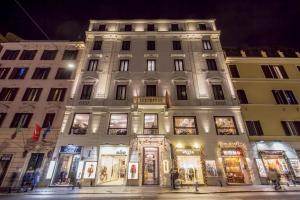 a large white building with a store front at night at Hotel 87 eighty-seven - Maison d'Art Collection in Rome