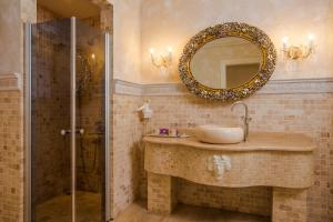 a bathroom with a sink and a shower with a mirror at Lukka Exclusive Hotel – Adult Only +12 in Kaş