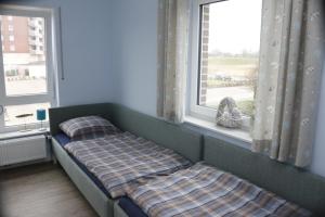 a bed in a room with a window at Strandgut in Horumersiel
