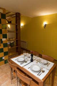 a table with plates and wine glasses on it at Apartamento turístico Revellin in Logroño