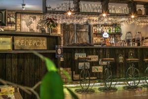 a bar with a wooden wall with a bicycle on it at Old Tree Villa & Restaurant in Oświęcim