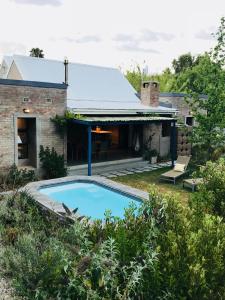 an external view of a house with a swimming pool at Blaauw Cottage in Riebeek-Kasteel