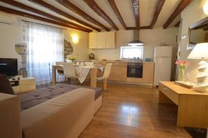 a living room with a kitchen and a dining room at Apartment Eleni in Rovinj