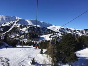 a ski lift going up a snow covered mountain at Grünseeappartement in Turracher Hohe +13 photos