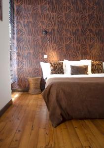 um quarto com uma cama e piso em madeira em La Casa Cosy, Appart'Hôtel em Biarritz