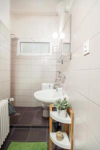 a white bathroom with a sink and a toilet at Internesto Brno in Brno