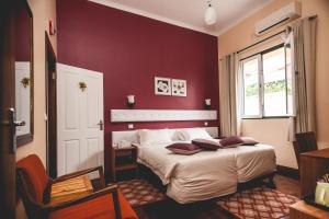 Ένα ή περισσότερα κρεβάτια σε δωμάτιο στο Palmeiras Guest House Maputo