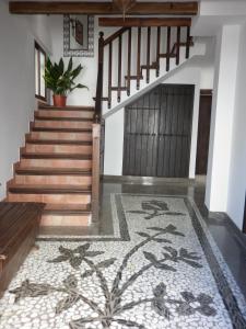 a hallway with stairs and a rug with a stair case at El Balcón del Albaicín in Granada