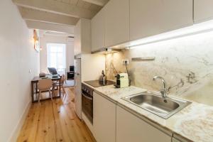 a kitchen with a sink and a counter top at Oporto Mezzanine - by ML Apartments in Porto