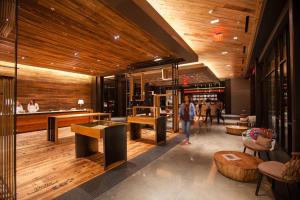 a person walking through a store lobby with wooden ceilings at The George in College Station