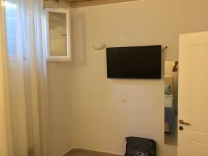 a flat screen tv on a wall in a room at Mykonos efis maisonette in Mikonos