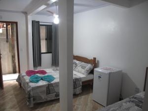 Postel nebo postele na pokoji v ubytování Suítes Cantinho da Pedra