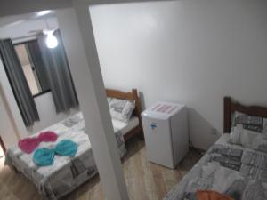 Postel nebo postele na pokoji v ubytování Suítes Cantinho da Pedra