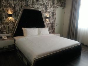 Postel nebo postele na pokoji v ubytování Wifi Boutique Hotel