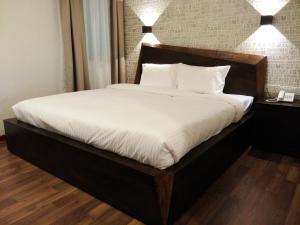 Postel nebo postele na pokoji v ubytování Wifi Boutique Hotel