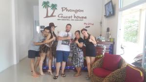 a group of people posing for a picture in a room at Phangan Guest House in Thong Sala