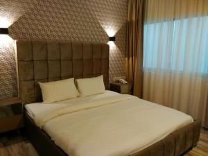 Postel nebo postele na pokoji v ubytování Wifi Boutique Hotel