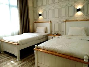 Postel nebo postele na pokoji v ubytování Wifi Boutique Hotel