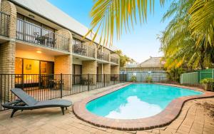 a swimming pool in front of a house at Nightcap at Kawana Waters Hotel in Kawana Waters