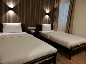 Postel nebo postele na pokoji v ubytování Wifi Boutique Hotel
