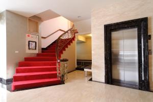 a red staircase in a house with a red carpet at Hotel South Sea in Kaohsiung