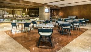 a restaurant with tables and chairs and a bar at Winford Resort and Casino Manila in Manila