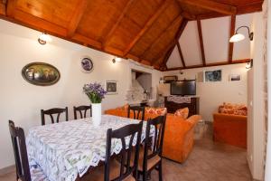 a dining room and living room with a table and chairs at Countryside Family Villa with Private Pool in Donje Selo na Šolti