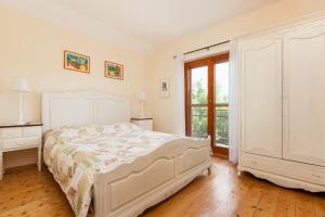 a white bedroom with a bed and a window at Countryside Family Villa with Private Pool in Donje Selo na Šolti +23 photos
