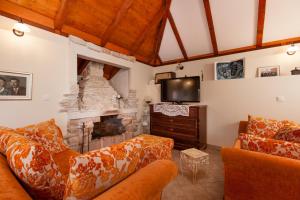 a living room with a couch and a fireplace at Countryside Family Villa with Private Pool in Donje Selo na Šolti