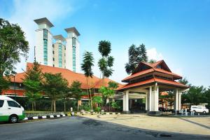 a building with a car parked in front of it at Nilai Springs Resort Hotel in Nilai