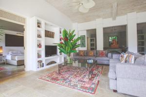 a living room with a couch and a table at Karmel Villa Thalduwa Island - Five Bedroom Luxury Villa with Private Pool in Ahangama