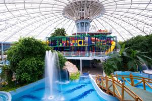a water park with a waterfall and a water slide at Kardos Apartman in Debrecen