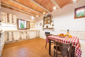 uma cozinha com uma mesa com uma toalha de mesa vermelha e branca em Agroturisme s' Horta em Capdepera