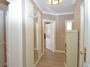 a hallway with pink walls and a white door at Villa Fernsicht - Apt. 03 in Ostseebad Sellin