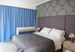 Postel nebo postele na pokoji v ubytování Hotel Kalithea