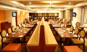 a large dining room with long tables and chairs at AVS Imperiaa Karaikal in kāraikāl