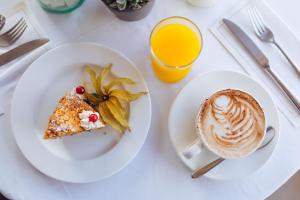 a table with a plate of food and a cup of coffee at Hotel Hostal Cuba in Palma de Mallorca