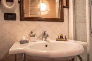 a white sink in a bathroom with a mirror at Bed & Breakfast Lo Teisson in Aosta