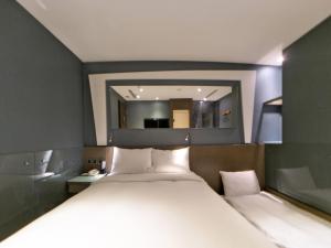 Ένα ή περισσότερα κρεβάτια σε δωμάτιο στο Beauty Hotels Taipei - Hotel B6