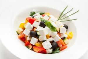 a white bowl filled with a salad with vegetables at Hotel Excelsior - Liburnia in Lovran