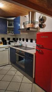 a kitchen with a red refrigerator and a sink at Fewo Bendig in Neuendorf-Sachsenbande