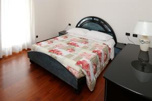 a bedroom with a bed and a table with a lamp at Round Venice in Marghera