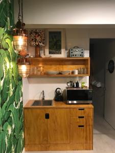 a kitchen with a sink and a microwave at Boogie Woogie Beach House in Old Bar