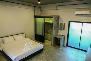 A bed or beds in a room at The Ele Hotel Ranong - SHA Extra Plus