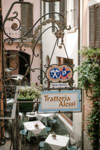 a sign that reads trattoria alessario on a building at Alessi Hotel Trattoria in Desenzano del Garda