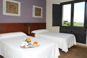 Katil atau katil-katil dalam bilik di Albergue Restaurante Casa Herminia