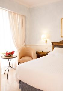 a hotel room with a bed, desk, chair and lamp at Apartamentos Guadalpin Boutique in Marbella