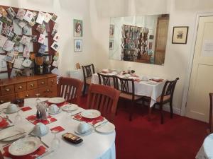 a dining room with a table and chairs and a mirror at The Gateway at Hest Bank in Lancaster