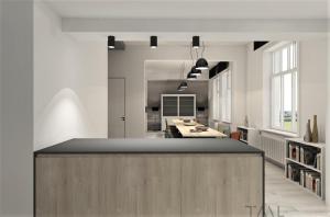 a kitchen with a island in the middle of a room at De Pastorie in Middelkerke